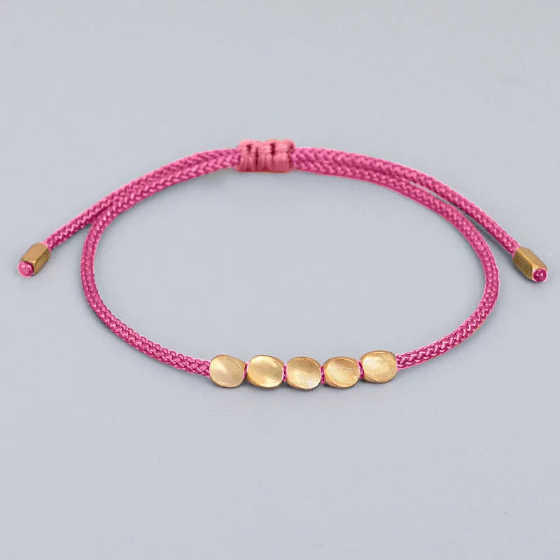 Bracelet de Chance tibétain rose tissé à la main pour la chance et la protection